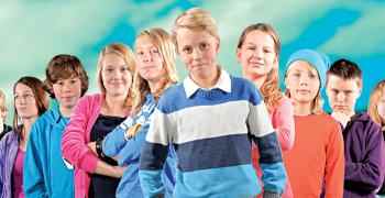 Barn på rekke ser mot kamera