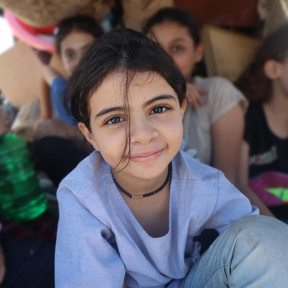 En jente sitter på et lasteplan, Gaza